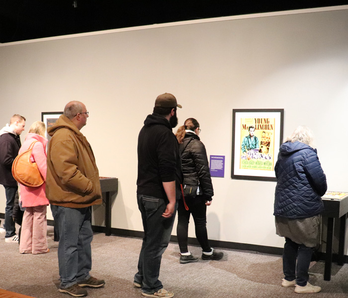 Museum guests explore an exhibit about Abraham Lincoln